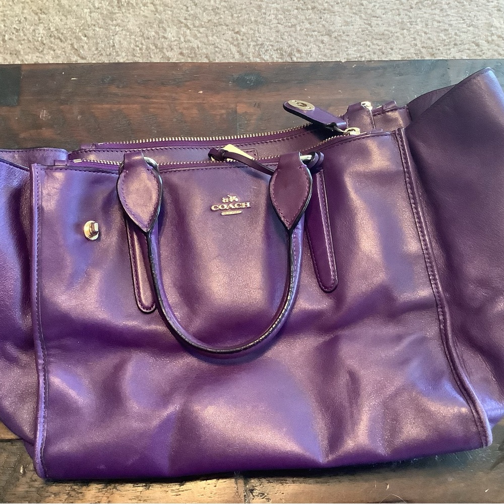 Coach gently used purple handbag with satin storage bag.